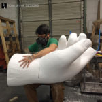 giant carved foam hand, an event or party prop of the Statue of Liberty torch
