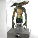 Gremlins movie prop and Clamp Logo acrylic display case