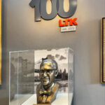 glass display case for bronze sculpture of a company founder