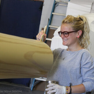 Giant Baseball Bat fiberglass sculpture being painted by Melissa Ocampo